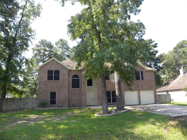 view of front of property with a garage, brick siding, fence, concrete driveway, and a front lawn