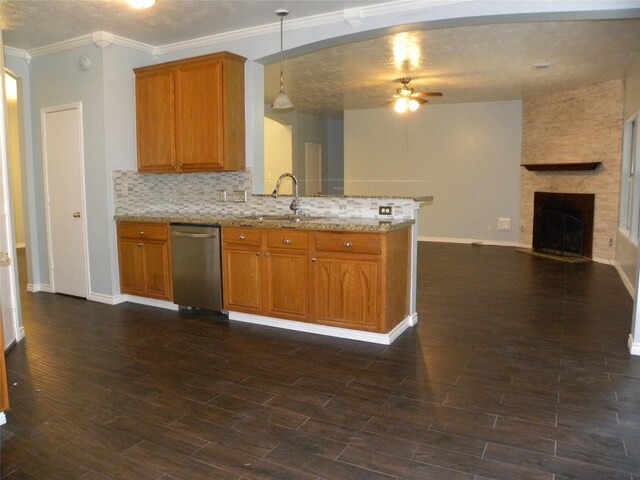 kitchen with dishwasher, open floor plan, dark wood-type flooring, hanging light fixtures, and a sink