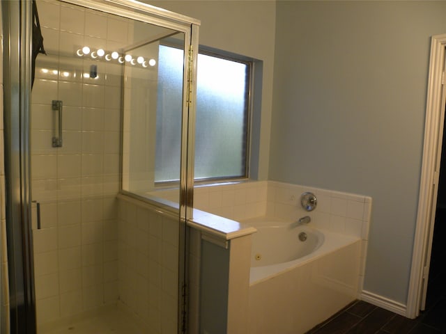 bathroom featuring independent shower and bath