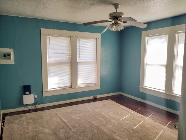 spare room featuring a textured ceiling and ceiling fan