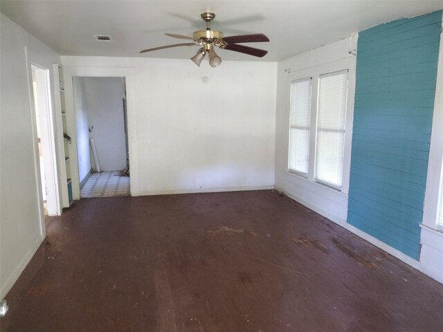 spare room with hardwood / wood-style flooring and ceiling fan