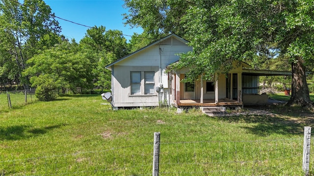 rear view of property with a yard