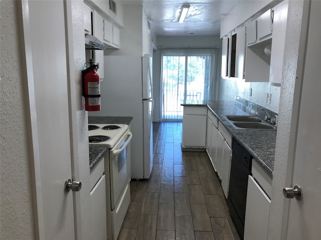 kitchen featuring dishwasher, electric range, white cabinetry, range hood, and sink