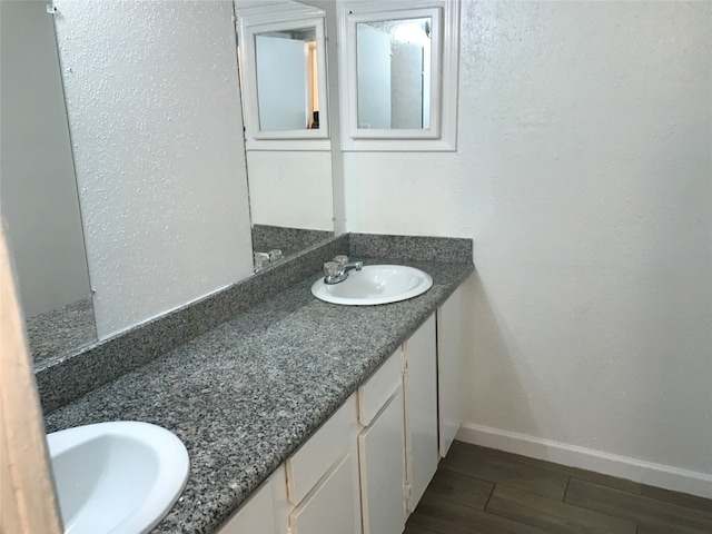 bathroom featuring hardwood / wood-style floors and dual vanity