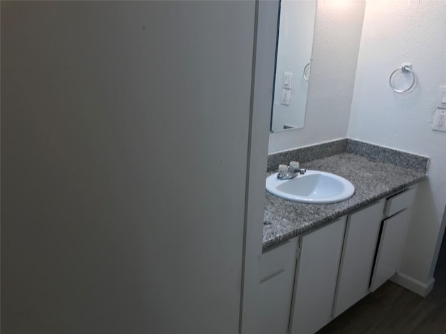 bathroom featuring vanity and hardwood / wood-style floors