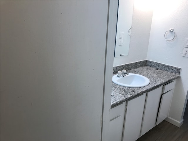 bathroom featuring vanity and hardwood / wood-style flooring