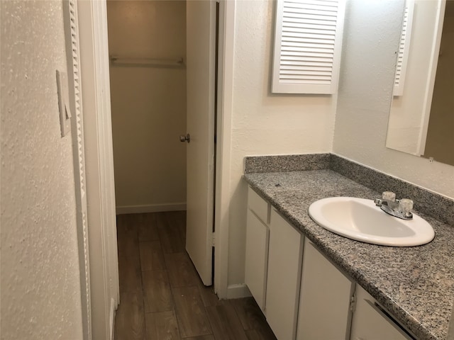 bathroom featuring hardwood / wood-style floors and large vanity