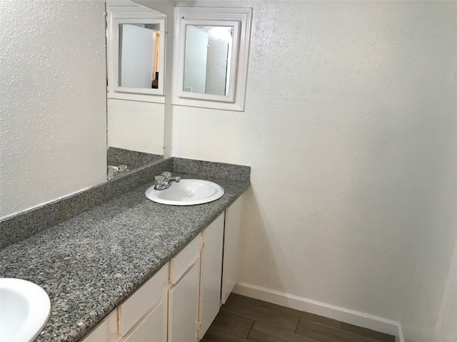 bathroom with vanity with extensive cabinet space and dual sinks