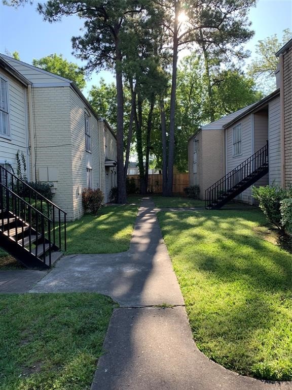 view of property's community with a lawn