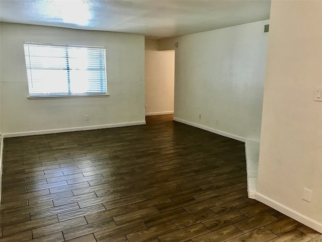 empty room featuring dark hardwood / wood-style flooring