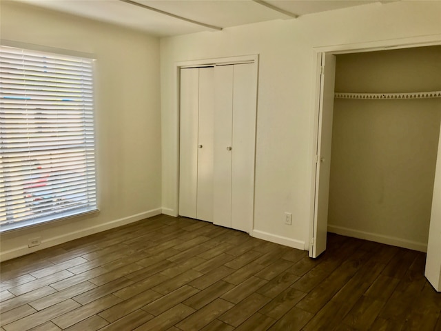 unfurnished bedroom featuring dark hardwood / wood-style floors