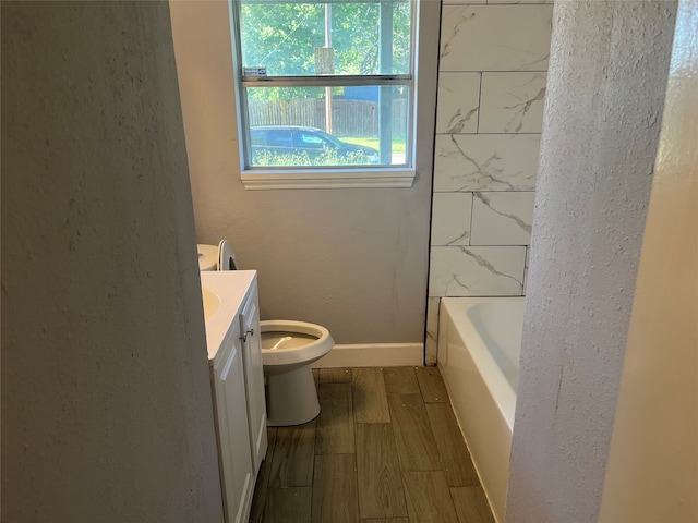 bathroom with wood-type flooring, vanity, and toilet