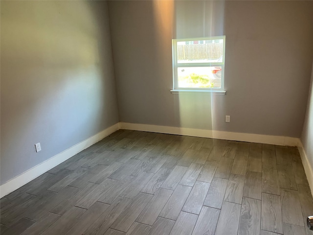 unfurnished room with hardwood / wood-style flooring