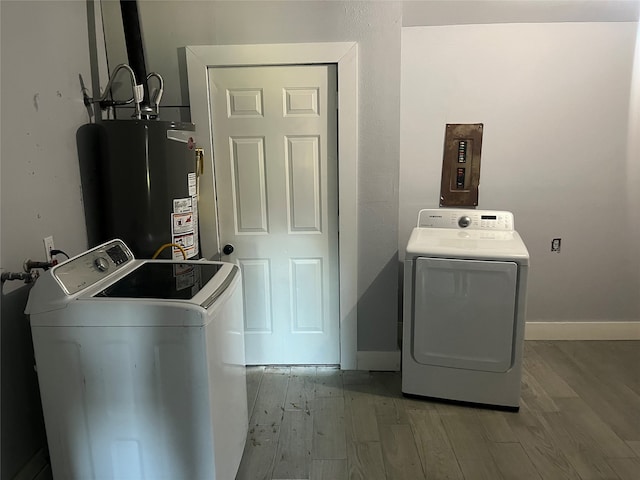 laundry room with wood-type flooring, washing machine and dryer, and gas water heater