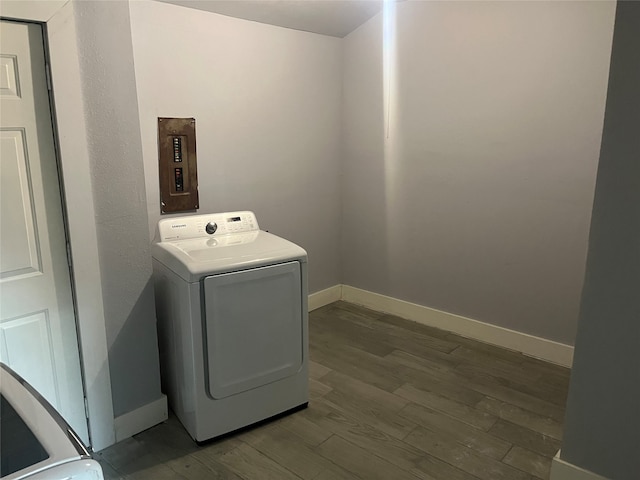 laundry room with dark wood-type flooring and washer / dryer