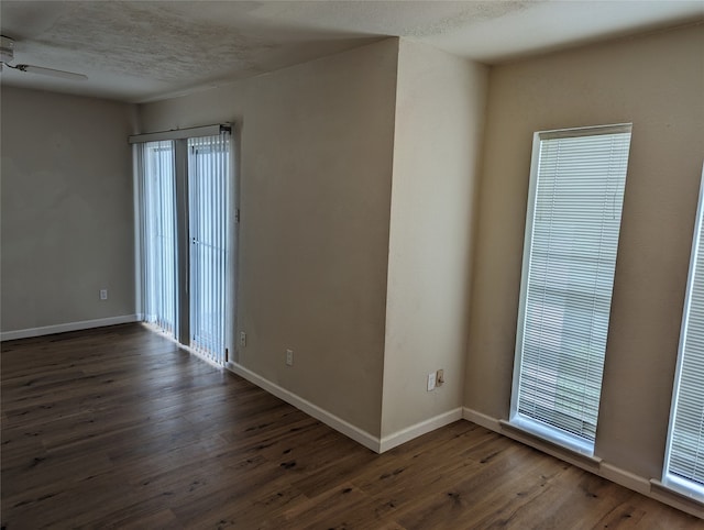 empty room featuring ceiling fan and dark hardwood / wood-style floors