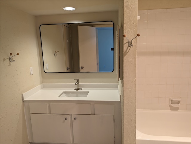 bathroom featuring vanity and a tub to relax in