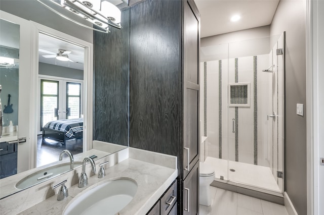 bathroom with walk in shower, ceiling fan, toilet, vanity, and tile floors