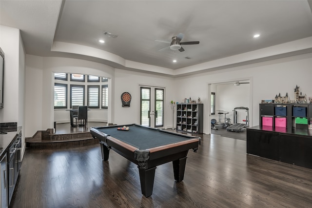 rec room with a tray ceiling, dark wood-type flooring, ceiling fan, and billiards