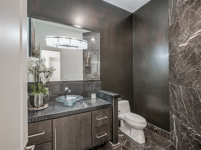 bathroom featuring toilet, tile flooring, and vanity