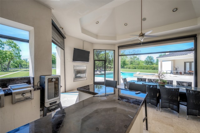 interior space featuring ceiling fan and a tray ceiling