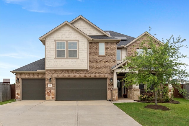 craftsman house with a front yard and a garage