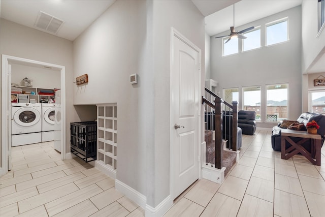 interior space with washing machine and dryer and a high ceiling