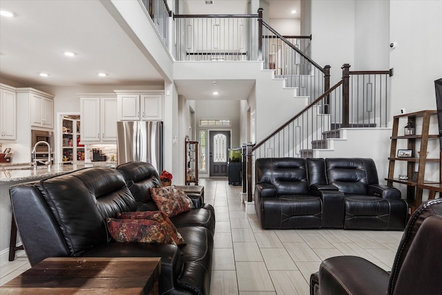 living room featuring a towering ceiling