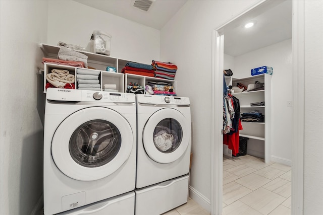 clothes washing area with separate washer and dryer