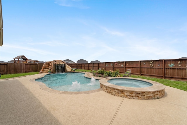 view of swimming pool featuring a patio area, pool water feature, and an in ground hot tub