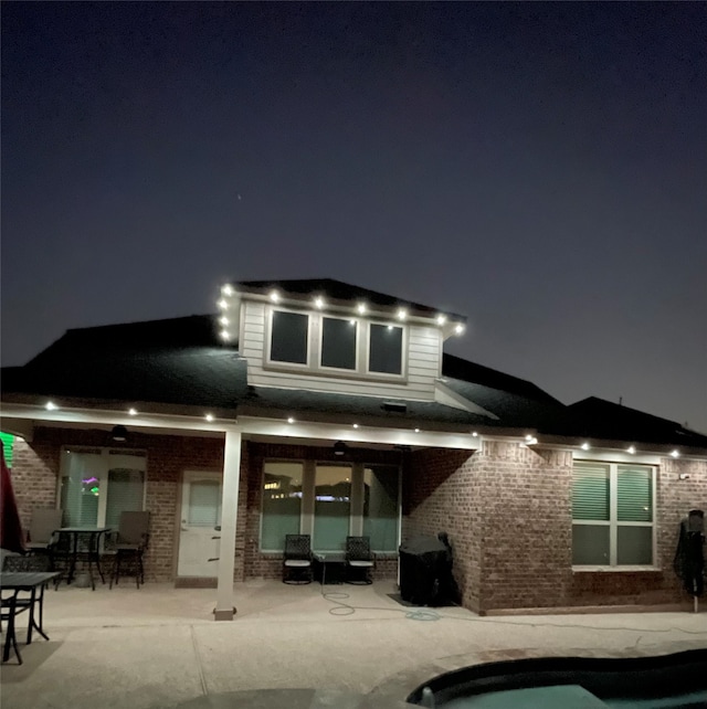 back house at night with a patio area