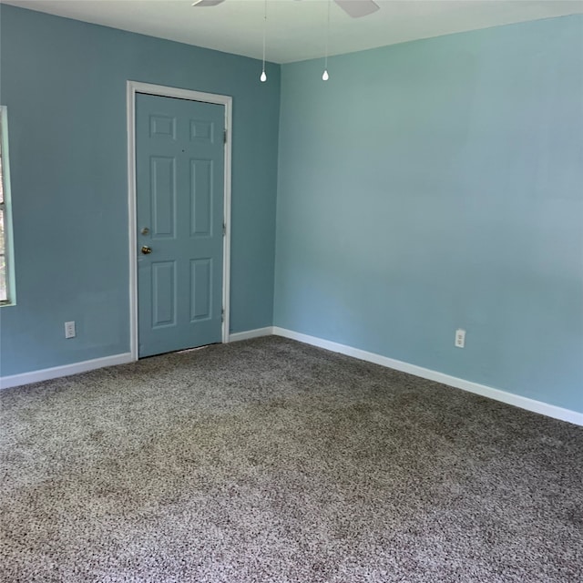 carpeted spare room featuring ceiling fan