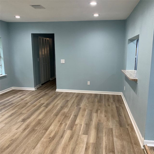 empty room with hardwood / wood-style flooring