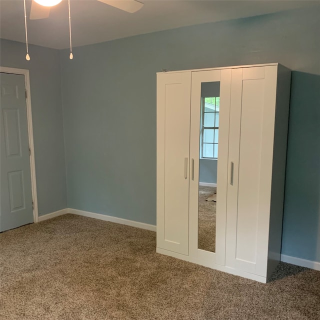 unfurnished bedroom with ceiling fan and carpet flooring