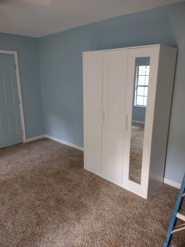 unfurnished bedroom featuring dark carpet