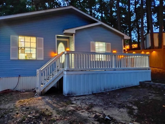 back of property with a wooden deck