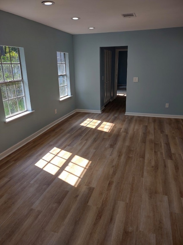 empty room with dark hardwood / wood-style floors