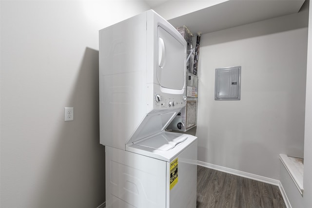 laundry area featuring stacked washer and dryer and dark hardwood / wood-style floors