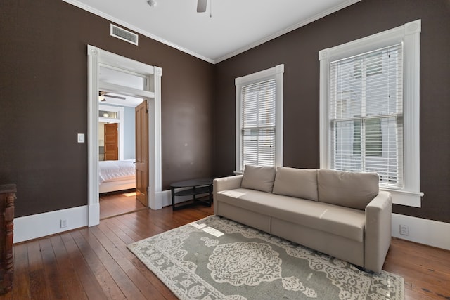 interior space featuring ceiling fan, dark hardwood / wood-style flooring, and ornamental molding