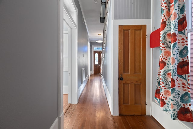 corridor with wood-type flooring