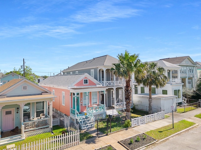 view of front of home with a balcony, a garage, and a porch