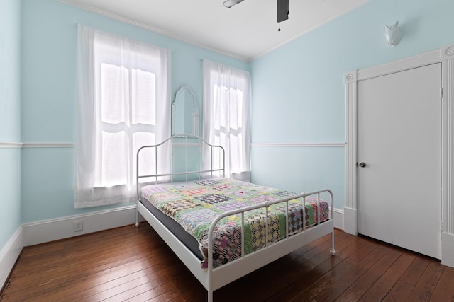 bedroom featuring ornamental molding, wood-type flooring, and ceiling fan