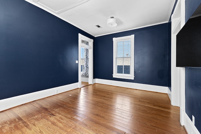 unfurnished room with hardwood / wood-style floors and ornamental molding