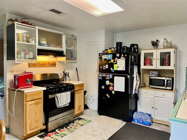 kitchen featuring light brown cabinetry, stainless steel appliances, white cabinets, and light tile floors