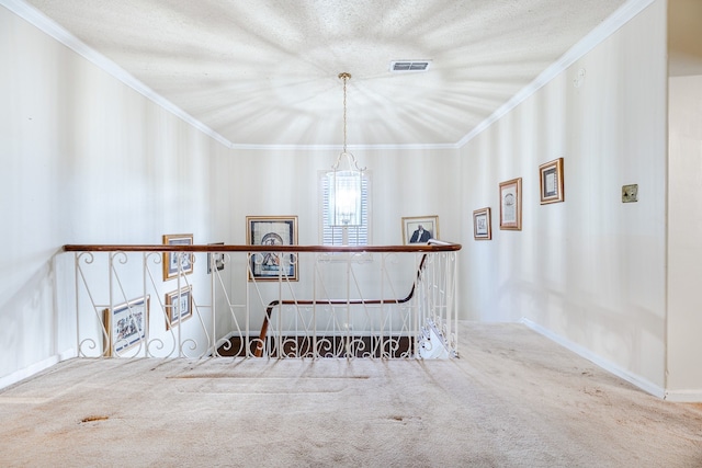 staircase with crown molding and carpet floors