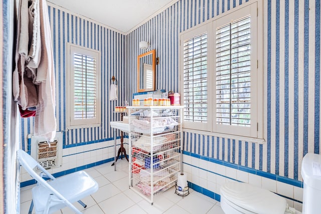 interior space featuring tile walls, light tile floors, and a healthy amount of sunlight