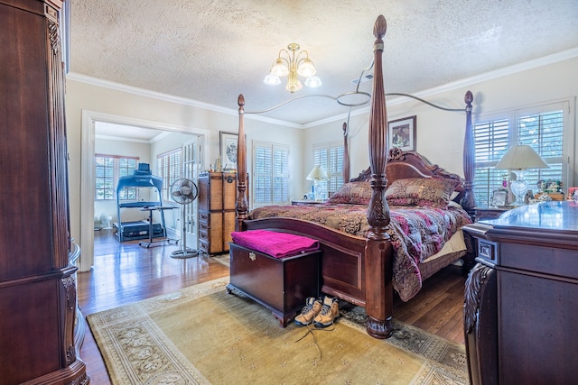 bedroom with hardwood / wood-style flooring, crown molding, a notable chandelier, and a textured ceiling