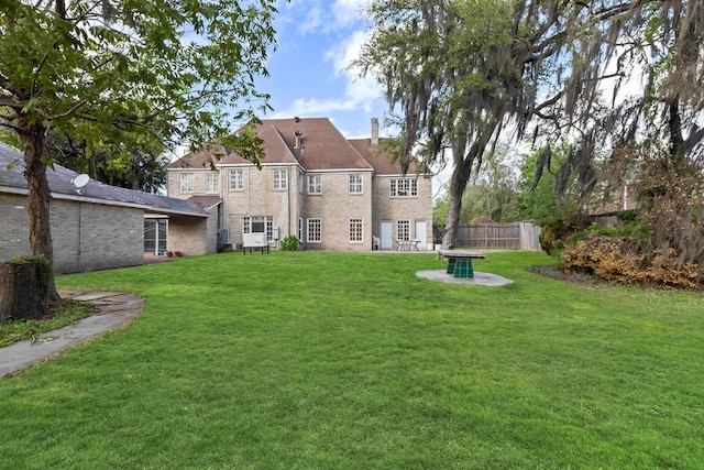 rear view of house with a yard