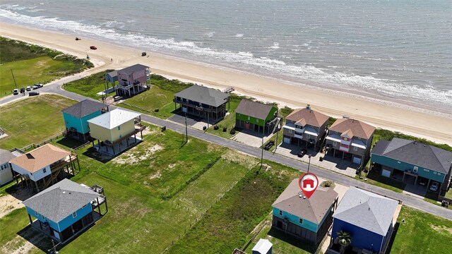 birds eye view of property with a view of the beach and a water view