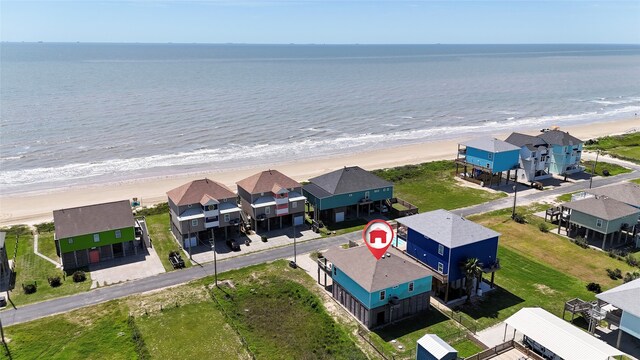 drone / aerial view with a beach view and a water view